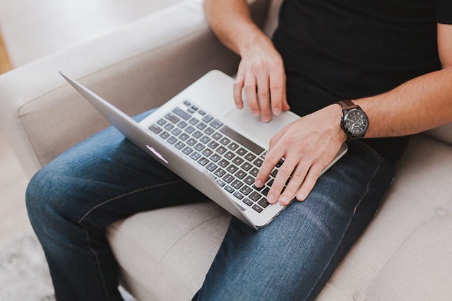 Man using laptop on couch