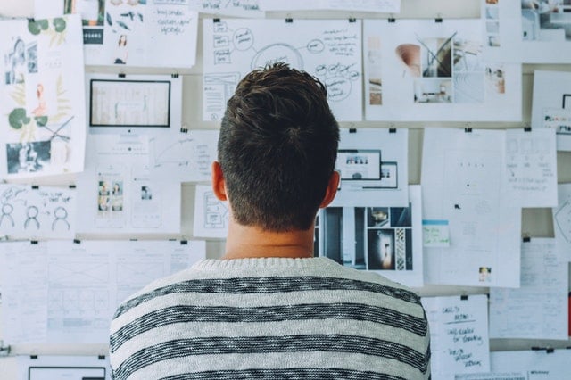 man looking at board