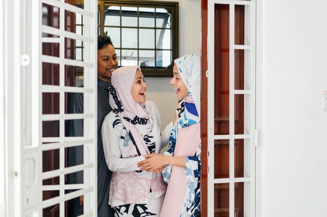 Two women standing by the door