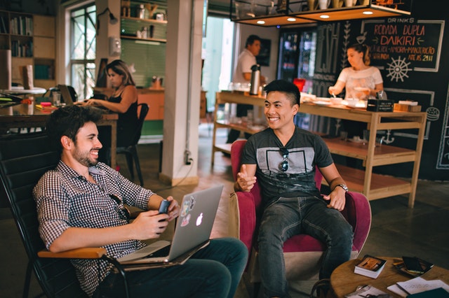 men having conversation sitting on chair