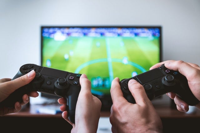 two person playing PS4