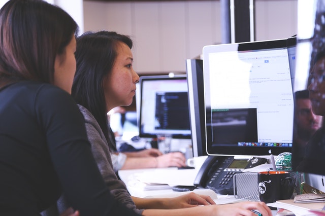 two woman and a computer